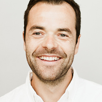 A photograph of Fabian Pfortmüller against a white background.